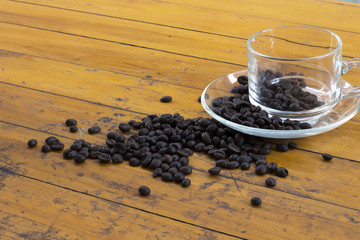 Fototapeta na wymiar coffee beans and coffee cup on wood background