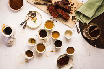 Overhead Coffee time table with chocolate cake sliced.