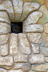 Background with ancient wall to the castle and small window