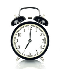 Alarm Clock isolated on white, in black and white, seven o'clock.