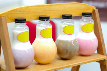 Row of colorful silky pudding in bottle on table