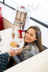 Fototapeta na wymiar Young woman in diner