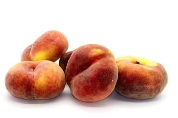Doughnut peaches close up on white.