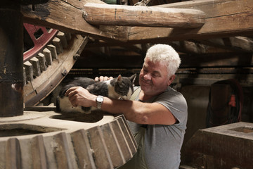 Miller stroking working mill cat