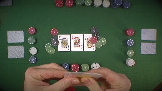 Man playing a game of poker, raises his bet and teaches your cards winning the game
