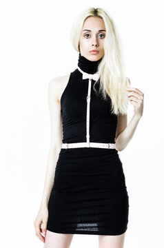 Blonde girl wearing black dress and white leather belt