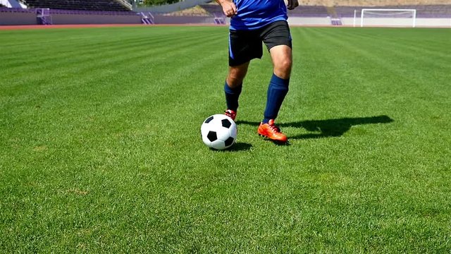 Footballer making tricks to avoid the defender, slow motion