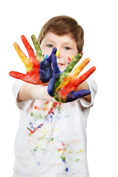 Portrait of beautiful little boy with paints on hands isolated o