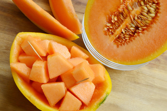 Honeydew melon makes a refreshing treat on a hot summer day, but it's also a low-calorie and healthy choice any time.
cut sweet Melon on wooden background .

