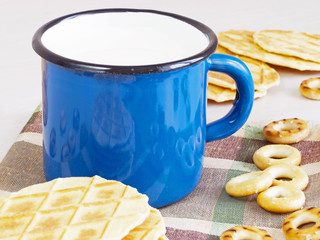 Mug of milk with cookies