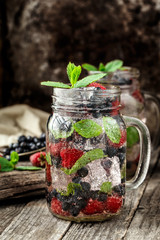 Detox drink with fresh berries in glass jars