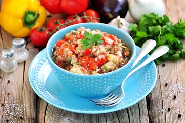 Appetizer (salad) of roasted eggplant, peppers, tomatoes, onions, garlic and coriander.