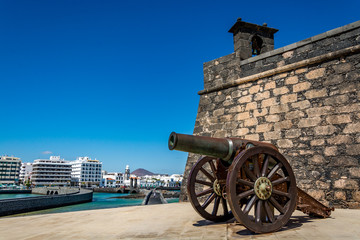 Castillo de San Gabriel - Saint Gabriel Castle in Arrecife and a cannon in front of it, Lanzarote island, Spain 