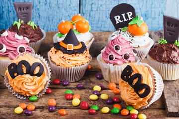 Halloween cupcakes with colored decorations