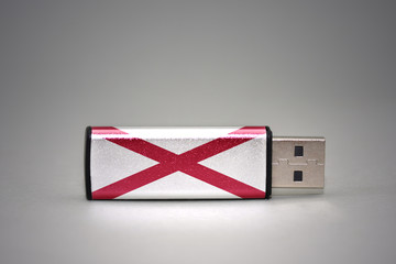 usb flash drive with the alabama state flag on gray background.