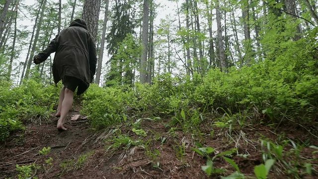 young girl walking in the woods one barefoot