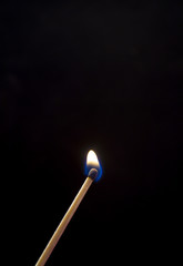 Burning match. A photo close up, a dark background