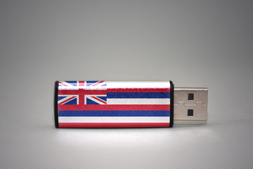usb flash drive with the hawaii state flag on gray background.