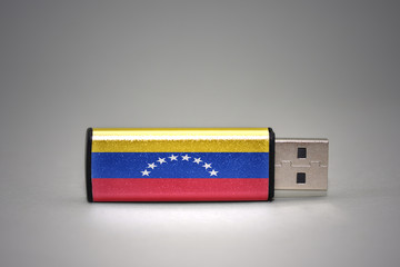 usb flash drive with the national flag of venezuela on gray background.