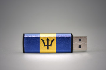 usb flash drive with the national flag of barbados on gray background.