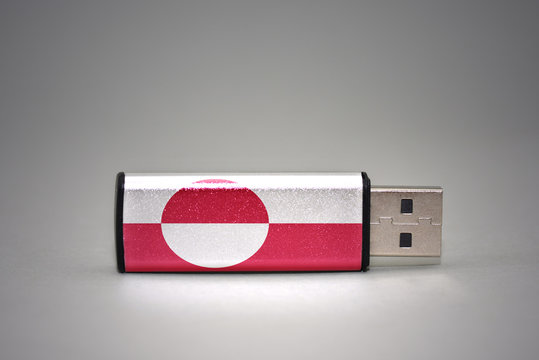 usb flash drive with the national flag of greenland on gray background.