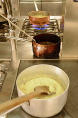 preparing dinner in restaurant kitchen