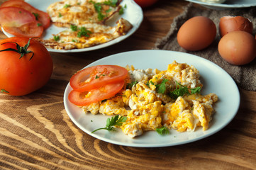 Scrambled, fried, boiled eggs on a wooden table