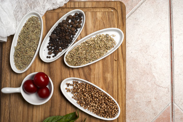 Fresh meat selection on wooden cutting board with spices in a wh