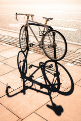 Fototapeta na wymiar Hipster single gear fixie bicycle locked to a metal stand on a pavement