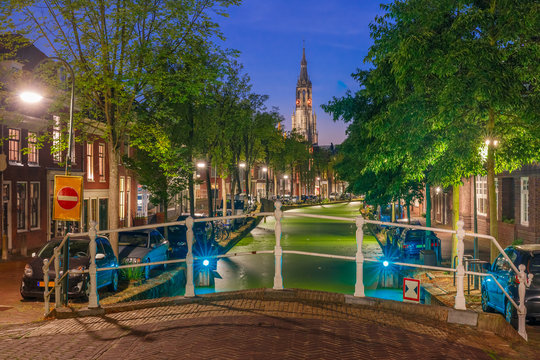 Night canal and Gothic Protestant Nieuwe Kerk church in Delft, Holland, Netherlands