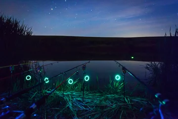Keuken spatwand met foto Fishing rods at night © Travel_Master