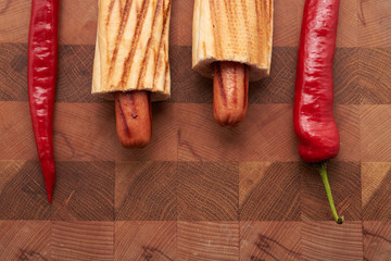 hot dogs and red chili pepper on the table