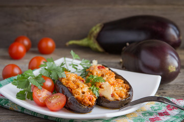 Baked stuffed eggplant with meat, vegetables and cheese.