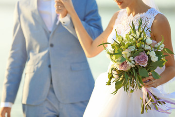 Happy wedding couple on river background