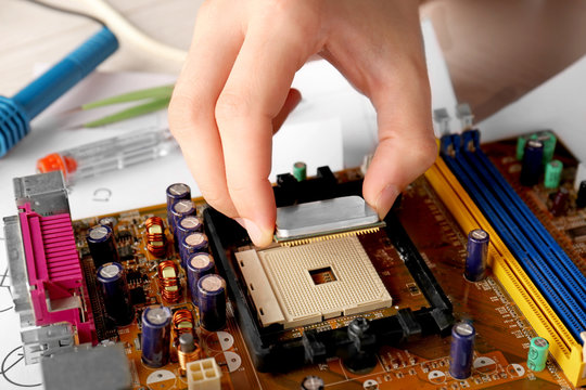 Man repairing motherboard, closeup