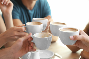 Fototapeta na wymiar Friends drinking coffee in cafe