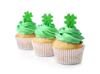Tasty cupcakes with clover, isolated on white. Saint Patrics Day concept