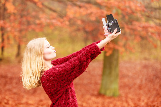 Woman with camera and smartphone take selfie photo