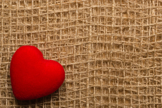 Red heart on abstract cloth background