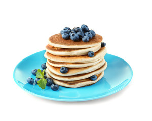 Tasty pancakes with blueberries on plate, isolated on white