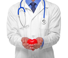Male doctor holding red heart on white background