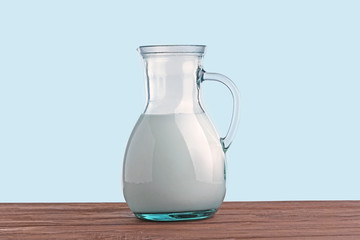 Milk in a jug on wooden table