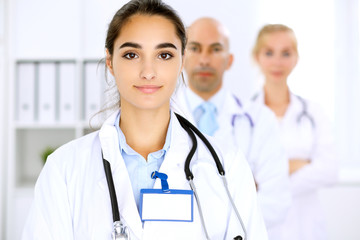 Happy doctor woman  with medical staff at the hospital