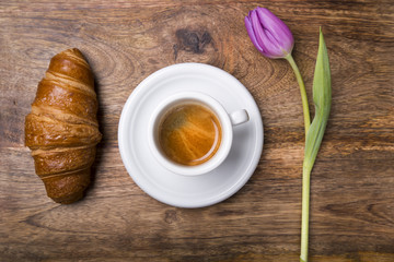 coffee, croissant and purple tulip for spring breakfast