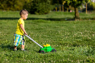 child mowing grass