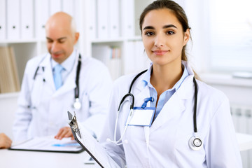 Fototapeta premium Happy doctor woman with medical staff at the hospital