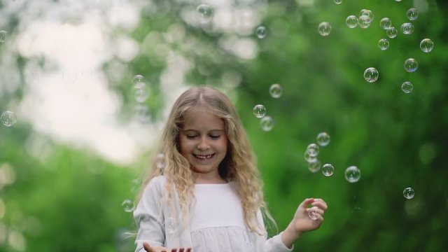 Beautiful girl with soap bubbles