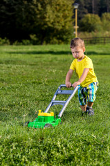 child mowing grass
