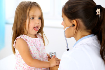 Doctor examining a little girl by stethoscope