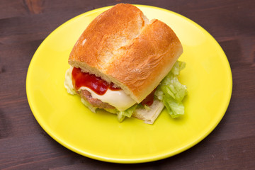 Meatball sandwich and cheese on a wooden table seen from above